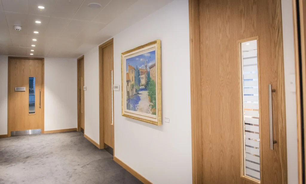 Oak veneered doorsets along a corridor