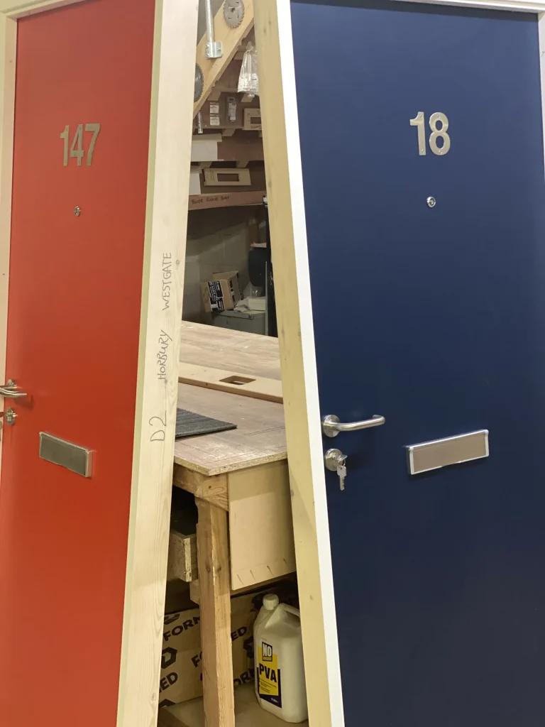 Red and navy painted entrance doors in the Carve workshop