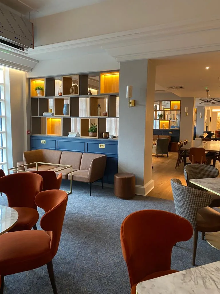 Lit display shelving dividing the lounge from the restaurant