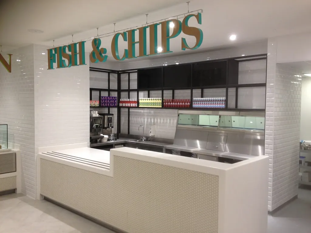 White solid surface servery counter in a fish and chip restaurant