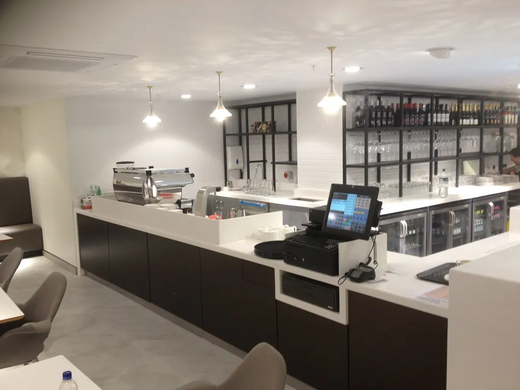 Solid surface service counter with a dark timber front