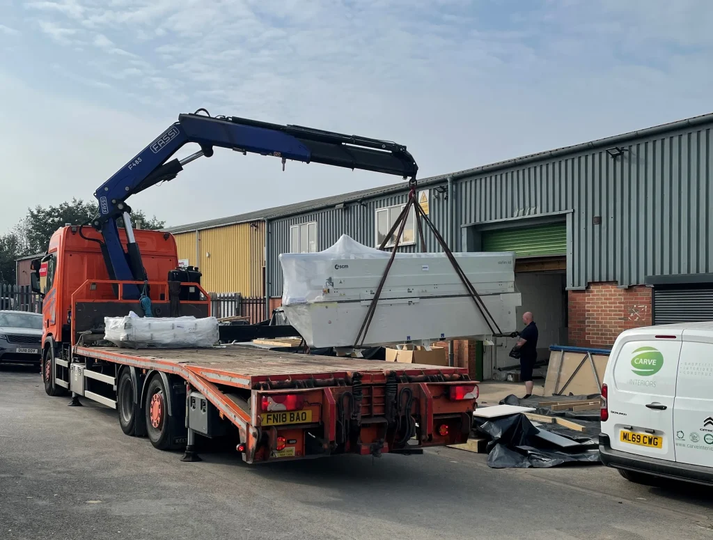 Finished joinery unit being craned onto a lorry outside the Carve workshop