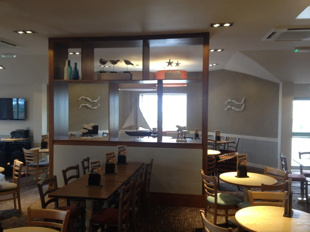 Dark timber display unit with nautical ornaments dividing the restaurant seating at Park Resorts