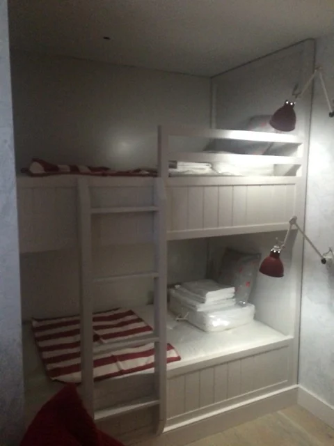 Full-height view of bespoke painted bunk bed joinery with integral ladder at Premier Marinas
