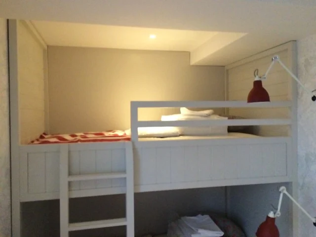 Upper bunk with safety rail, panelled sides and recessed downlight in a Premier Marinas bunk room