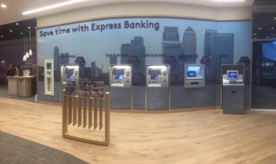 Express banking area with a row of ATMs built into a secure wall